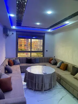 a living room with a couch and a table at AMB appartements in Oulad Akkou