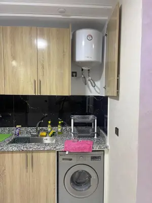 a kitchen with a washing machine and a sink at AMB appartements in Oulad Akkou