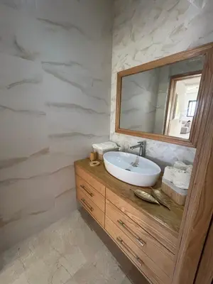 a bathroom with a sink and a mirror at villa prestigieuse avec piscine in Oulad Akkou