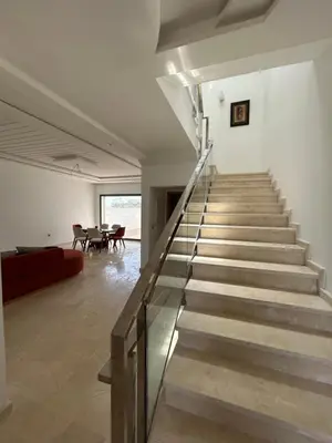 a staircase in a house with a living room at villa prestigieuse avec piscine in Oulad Akkou