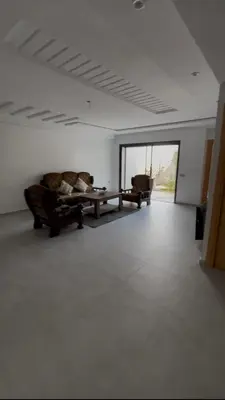 a living room with two couches and a table at villa prestigieuse avec piscine in Oulad Akkou