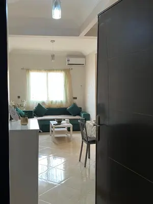 a living room with a couch and a refrigerator at Appartement Marrakech in Oulad Akkou