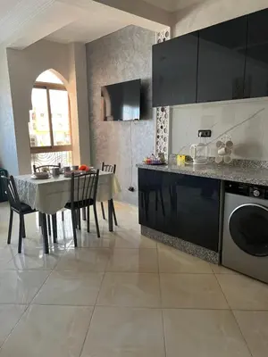 a kitchen with a table and a dining room at Appartement Marrakech in Oulad Akkou