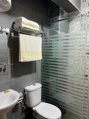 a bathroom with a white toilet and a sink at Appartement Marrakech in Oulad Akkou