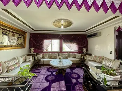 a living room with couches and a table at Le meilleur appartement à côté du grand stade sportif de Fès in Fès