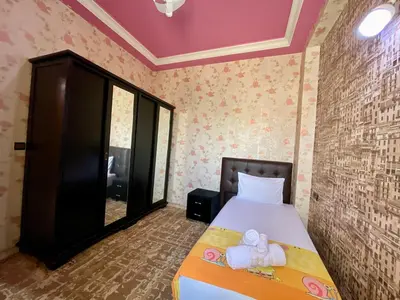 a bedroom with a bed with towels on it at Le meilleur appartement à côté du grand stade sportif de Fès in Fès