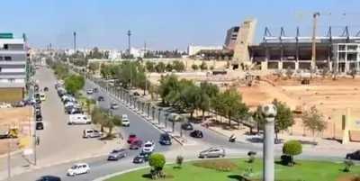 a street with cars parked in a parking lot at Le meilleur appartement à côté du grand stade sportif de Fès in Fès