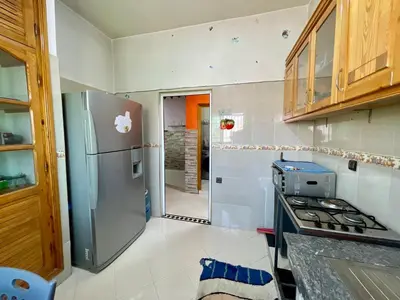 a kitchen with a stainless steel refrigerator and a stove at Le meilleur appartement à côté du grand stade sportif de Fès in Fès