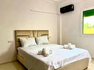 a bedroom with a bed with towels on it at Residence Nasr Fes - Family & Traveler Apartments in Fès