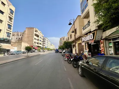 a street with a car parked on the side of the road at Residence Nasr Fes - Family & Traveler Apartments in Fès