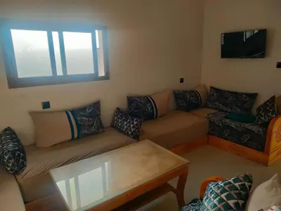 a living room with a couch and a table at Dar essaouira in Oulad Akkou
