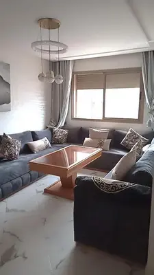 a living room with a couch and a coffee table at إقامة ياسمينه in Oulad Akkou