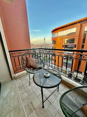 a balcony with a table and chairs on a building at Le Scandinave de Marrakech-Gueliz-Centre in Oulad Akkou