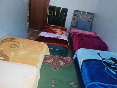 a group of three beds in a room at Gîte Ayour Atlas Tachddirt in Tacheddirt