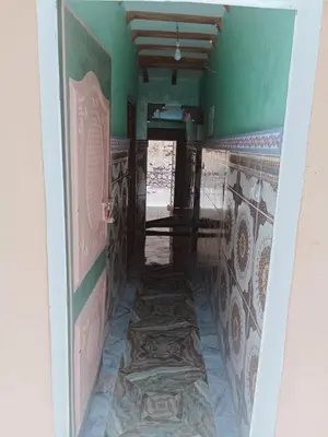 a hallway in a house with green walls and tiles at Gîte Ayour Atlas Tachddirt in Tacheddirt