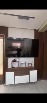 a living room with a large tv on the wall at عمارة المودة 2 in Oulad Akkou
