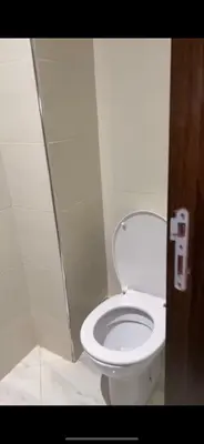 a bathroom with a white toilet in a stall at عمارة المودة 2 in Oulad Akkou