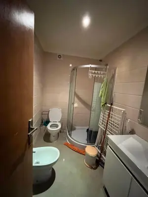 a bathroom with a shower and a toilet and a sink at Assilah in Oulad Akkou