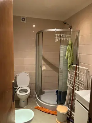 a bathroom with a shower with a toilet and a sink at Assilah in Oulad Akkou
