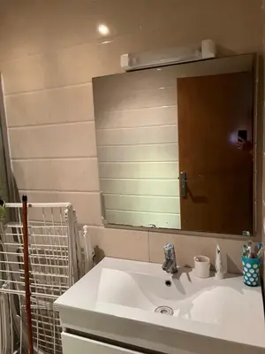 a bathroom with a sink and a large mirror at Assilah in Oulad Akkou
