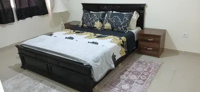 a bedroom with a bed and a night stand at Prestige house in Oulad Akkou