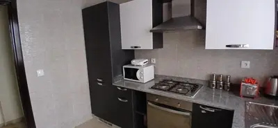 a kitchen with a microwave and a stove top oven at Prestige house in Oulad Akkou