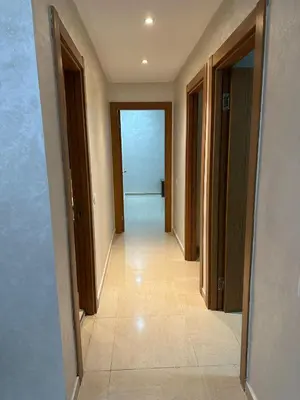 an empty hallway with doors and a tile floor at Prestige house in Oulad Akkou