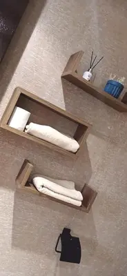two wooden shelves with towels in a bathroom at Prestige house in Oulad Akkou