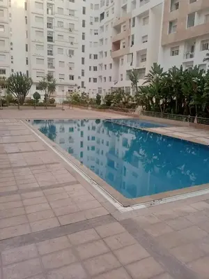 a large swimming pool in front of a building at Prestige house in Oulad Akkou