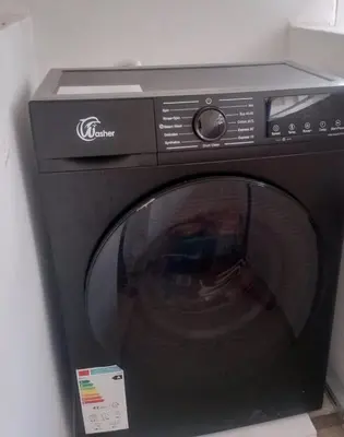 a black microwave oven with its door open at Prestige house in Oulad Akkou