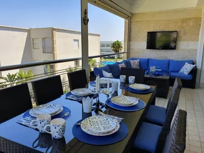 a table with blue and white dishes on a balcony at Le bleu d Olablanca in Zaouia Sidi Rahkal