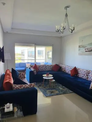 a living room with blue couches and a table at Le bleu d Olablanca in Zaouia Sidi Rahkal