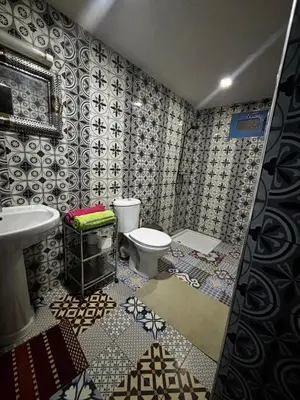 a bathroom with a toilet and a sink at Hostel Khamlia in Khamliya