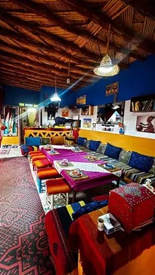 a room with a long table and colorful chairs at Hostel Khamlia in Khamliya