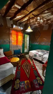a bedroom with two beds and a rug on the floor at Hostel Khamlia in Khamliya