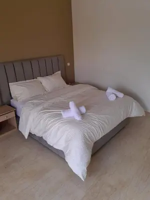 a bed with two white towels on it at Villa Nomade Residence 3 chambres avec piscine in Oulad Snaguia