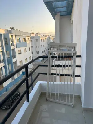 a balcony with a gate on top of a building at Social appartement at Martil in Oulad Akkou