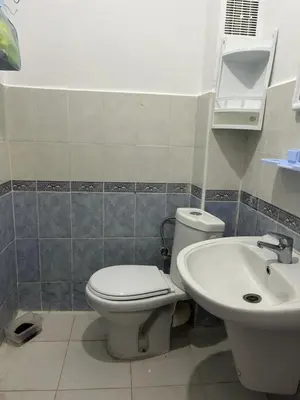 a bathroom with a toilet and a sink at Social appartement at Martil in Oulad Akkou
