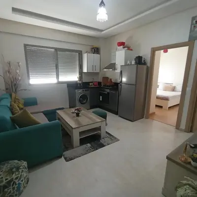 a living room with a couch and a table at Vacation apartment in Oulad Akkou