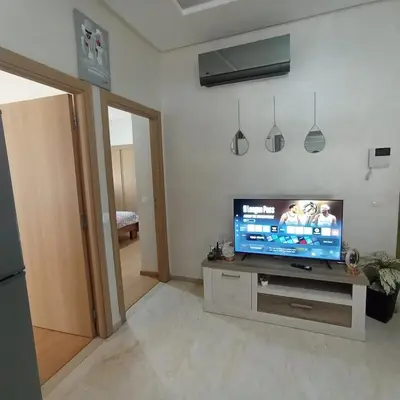 a living room with a flat screen tv on a table at Vacation apartment in Oulad Akkou