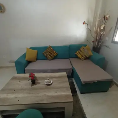 a blue couch in a living room with a coffee table at Vacation apartment in Oulad Akkou
