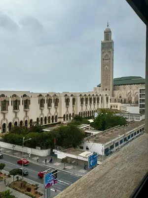 a large building with a clock tower and a street at Appartment central view on Hassan II in Oulad Akkou