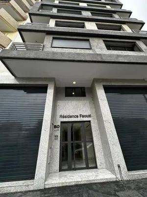a building with a sign that reads healthcare research at Appartment central view on Hassan II in Oulad Akkou