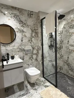 a bathroom with a toilet and a sink and a shower at Prestige Apartment in Fès