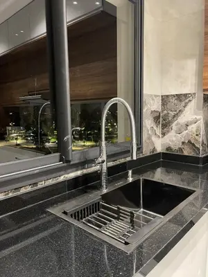 a sink in a kitchen with a window at Prestige Apartment in Fès