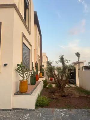 a building with potted plants on the side of it at Villa À Kenza marrakech in Oulad Akkou