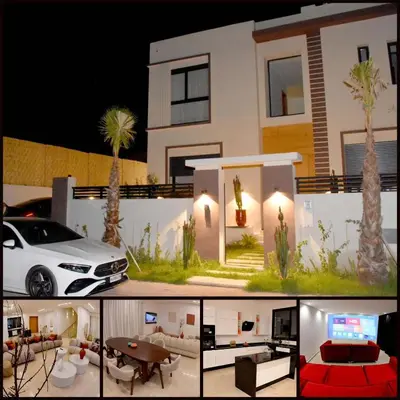 a white car parked in front of a house at Villa À Kenza marrakech in Oulad Akkou