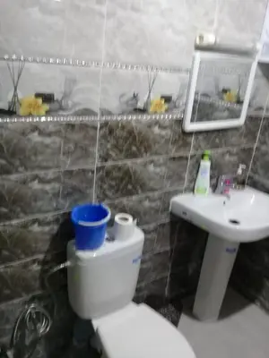 a bathroom with a toilet and a sink at appartement meuble in Oulad Akkou