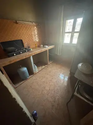 a kitchen with a table and a window in a room at Merzouga in Merzouga