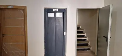 a walk in closet with a door and a staircase at Bahia Sakan in Oulad Akkou
